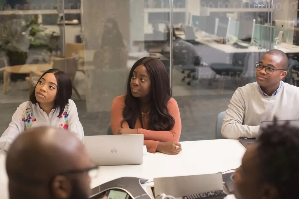 Illustrative photograph of colleagues in a structured review meeting, representing regulatory and compliance work.